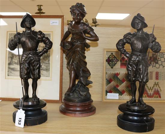 A pair of bronzed spelter figures of Spanish soldiers and a larger figure La Fermiere largest 38cm